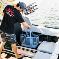 MarineWarehouse/Man-swoting-the_Mission-CASSI-70L-gear-tote-in-a-boats-storage-compartment__63153.1779985751